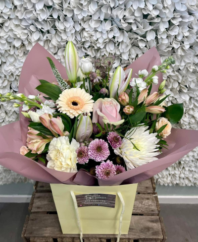 Softly Sweet - A soft and elegant bouquet in delicate pink, cream and white tones, beautifully complemented by fresh greenery.