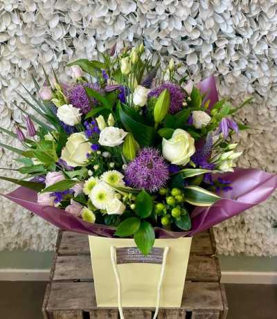 Violet Charm - A beautiful bouquet in elegant purple, white and soft pink tones, complemented by fresh greenery for a graceful finish.