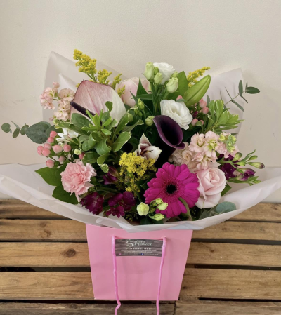 Raspberry Kiss - A vibrant bouquet combining soft pinks, crisp whites and rich berry tones with fresh greenery for a bright, uplifting finish.