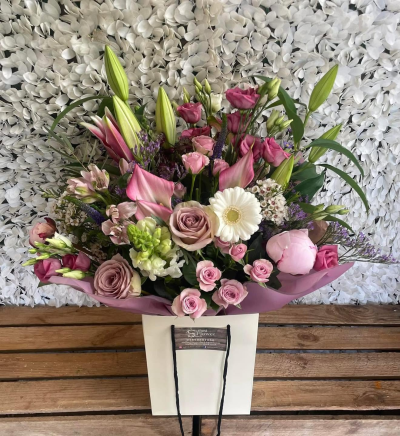 Rosewood - A luxurious bouquet in dusky pink, soft mauve and creamy white tones, finished with fresh greenery for a rich and elegant look.